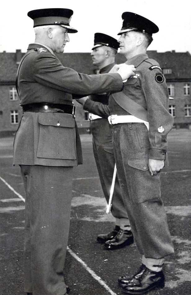  Major Austin 'Bobby' Joyce receiving his MBE in 1952 (Image: Spink&Son/BNPS) 